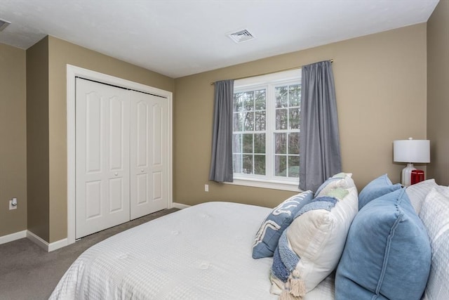 carpeted bedroom with baseboards, visible vents, and a closet