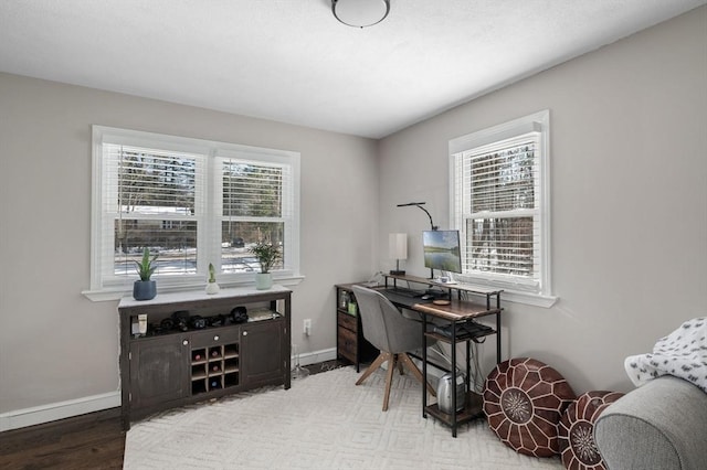 home office with baseboards and light wood-style floors