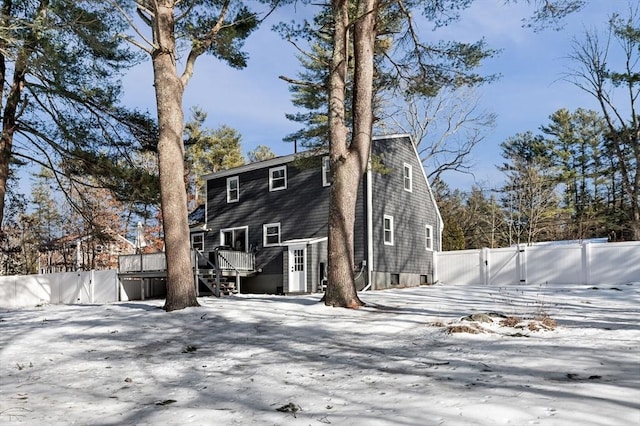 view of front of property featuring a gate, fence, a wooden deck, and stairs