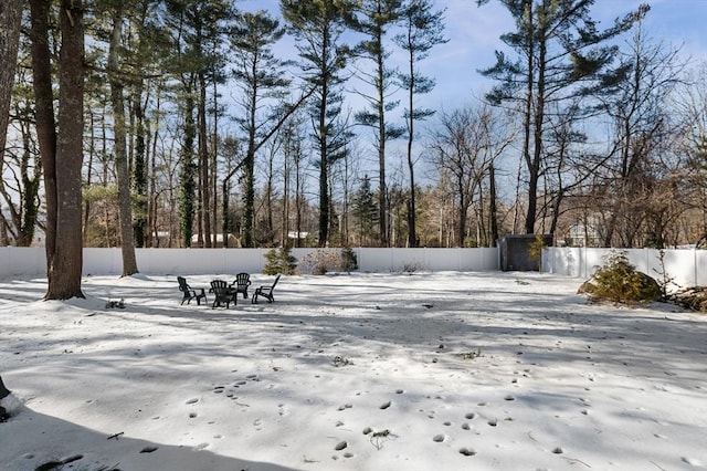 yard layered in snow with fence