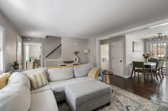 living area with baseboards and dark wood-style flooring