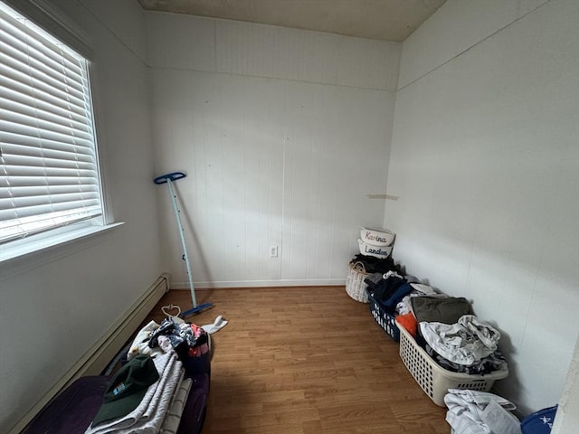 interior space featuring baseboards and wood finished floors
