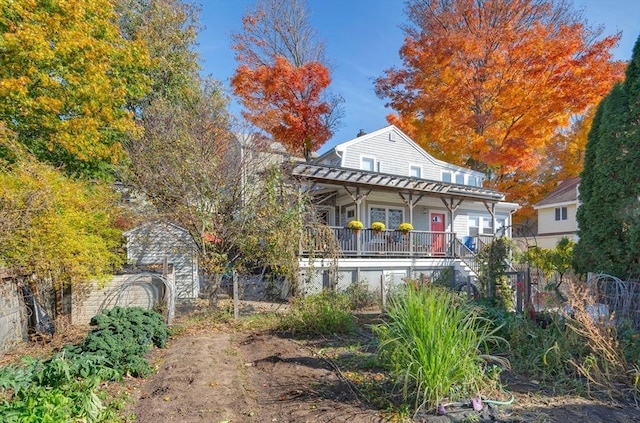 rear view of property with covered porch