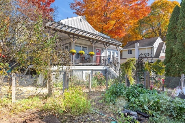 back of house featuring covered porch