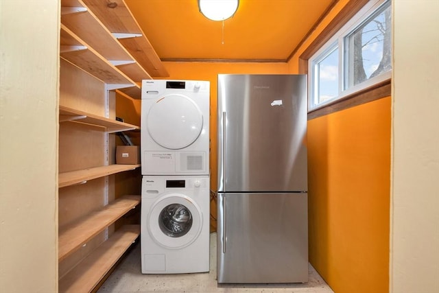 laundry room with stacked washing maching and dryer