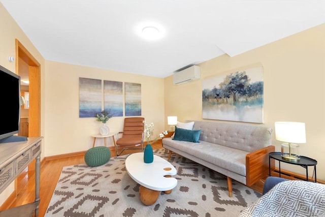 living room with a wall mounted AC and light hardwood / wood-style floors