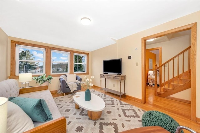 living room featuring lofted ceiling and wood-type flooring