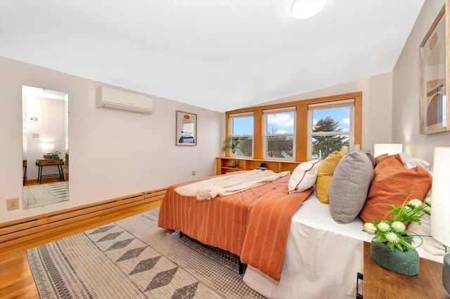 bedroom with lofted ceiling, hardwood / wood-style flooring, and an AC wall unit