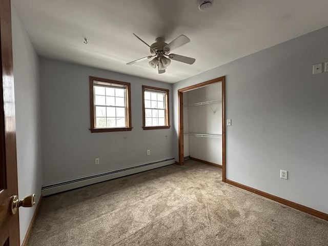 unfurnished bedroom with baseboards, a ceiling fan, light colored carpet, a baseboard heating unit, and a closet