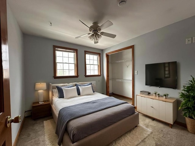 bedroom featuring a baseboard radiator, light carpet, and baseboards