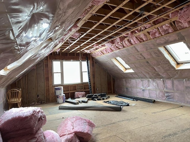 attic featuring a skylight