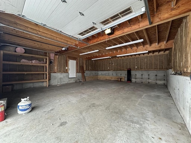 garage with electric panel and a garage door opener