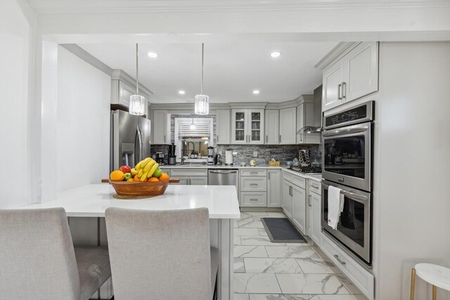 105 Cross St, Randolph, MA 02368 - kitchen featuring a breakfast bar, decorative light fixtures, a kitchen island, stainless steel appliances, and backsplash