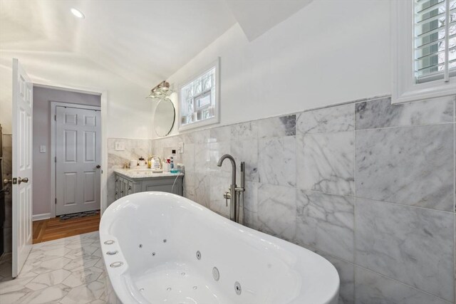 105 Cross St, Randolph, MA 02368 - bathroom with vanity, a washtub, and tile walls