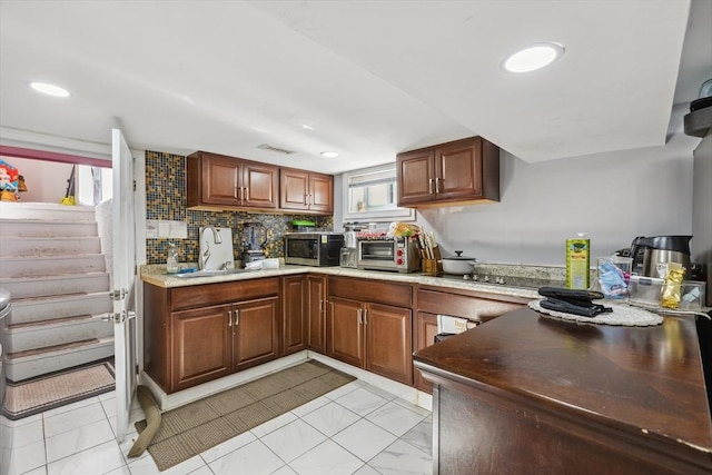 105 Cross St, Randolph, MA 02368 - kitchen featuring tasteful backsplash, sink, and a healthy amount of sunlight