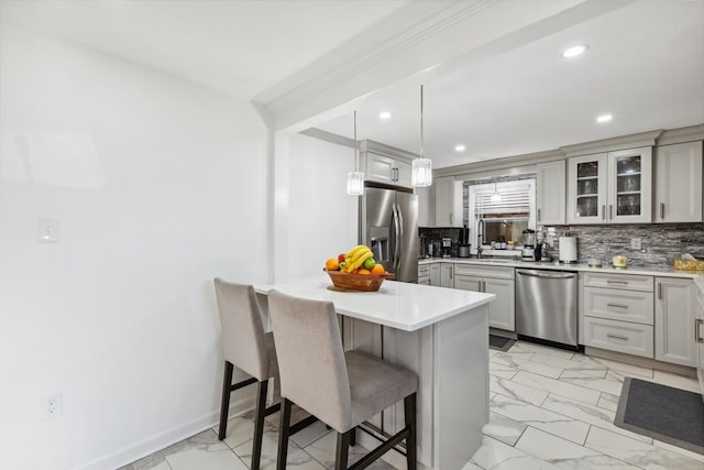 105 Cross St, Randolph, MA 02368 - kitchen featuring decorative light fixtures, a breakfast bar area, decorative backsplash, and appliances with stainless steel finishes