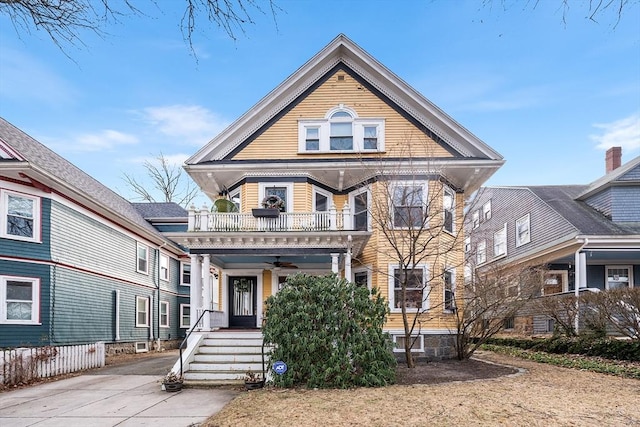 victorian-style house with a balcony and ceiling fan