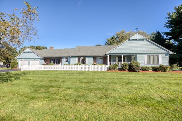 ranch-style home featuring a garage and a front lawn