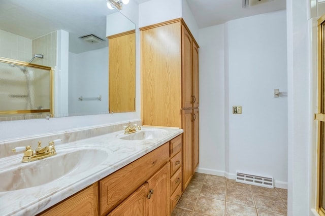 bathroom with tile patterned flooring, vanity, and a shower with shower door