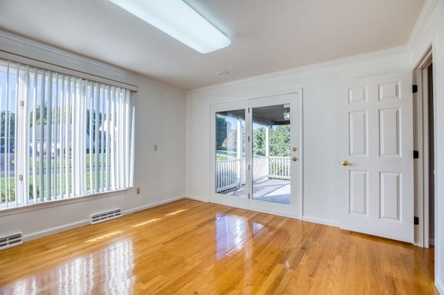 unfurnished room featuring light wood-type flooring and ornamental molding