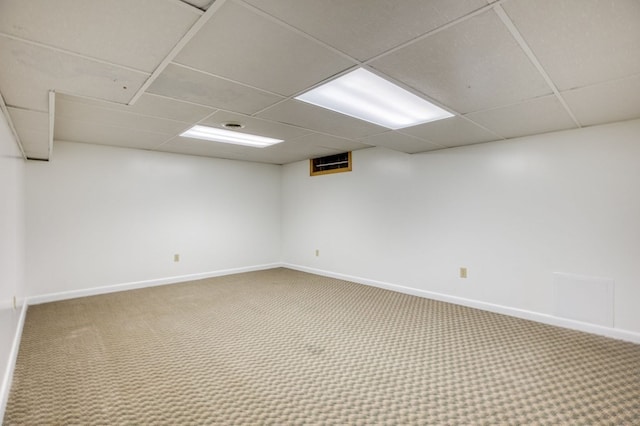 basement with carpet and a drop ceiling