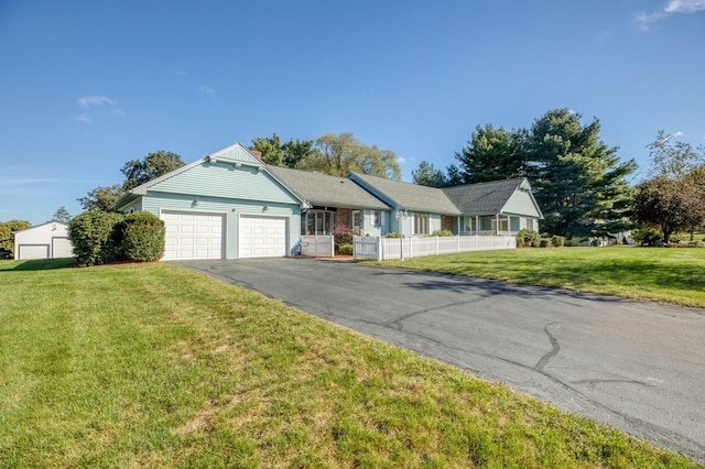 view of front of property featuring a front yard and a garage