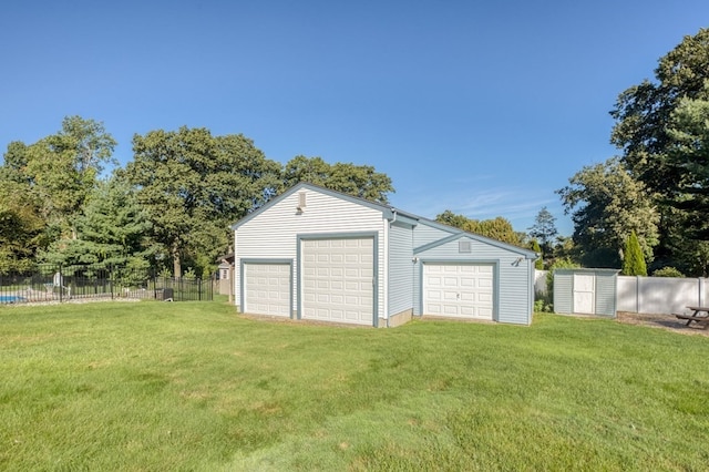 garage featuring a lawn