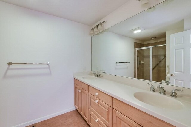 11 Dillingham Way Unit 11, Plymouth, MA 02360 - bathroom with a shower stall, double vanity, tile patterned floors, and baseboards