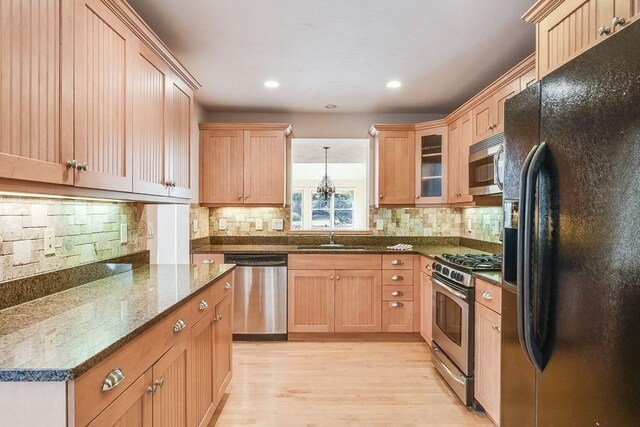 11 Dillingham Way Unit 11, Plymouth, MA 02360 - kitchen featuring appliances with stainless steel finishes, a sink, light wood-style floors, backsplash, and glass insert cabinets