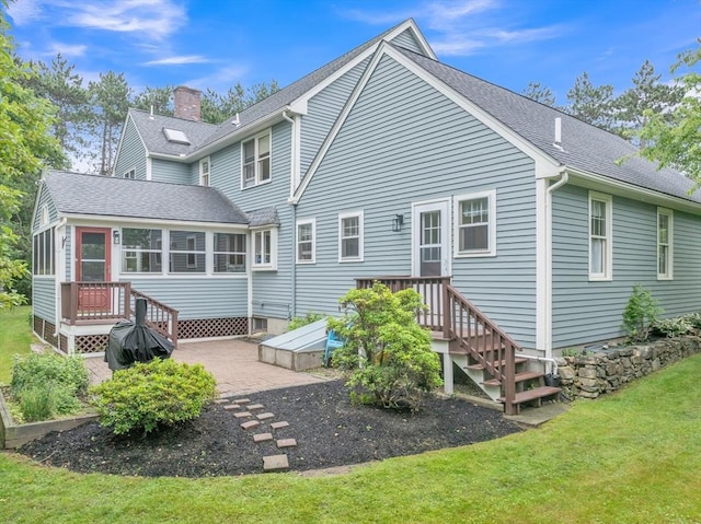 121 Merriam Rd, Grafton, MA 01519 - back of property with roof with shingles, a sunroom, a chimney, and a lawn