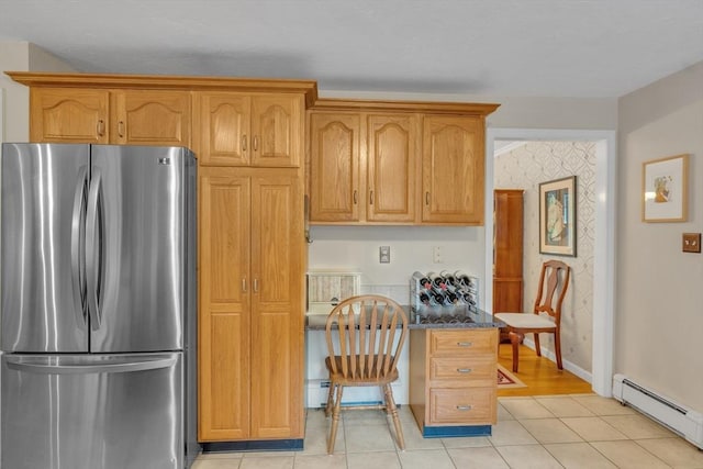 121 Merriam Rd, Grafton, MA 01519 - kitchen with freestanding refrigerator, baseboard heating, light tile patterned flooring, a desk, and dark stone counters