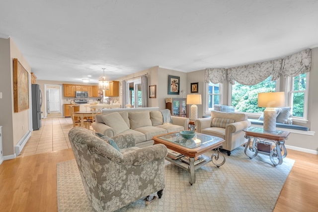 121 Merriam Rd, Grafton, MA 01519 - living area featuring a baseboard radiator, light wood-type flooring, and a chandelier