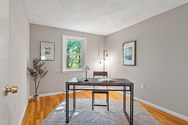 office with baseboards and light wood finished floors
