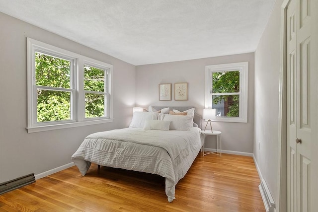 bedroom featuring light wood-type flooring and baseboards
