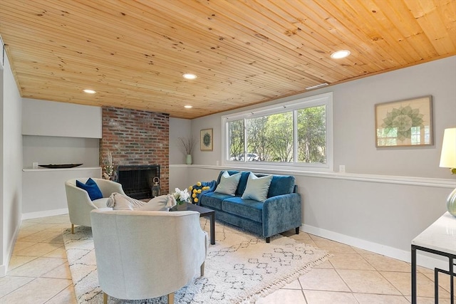living area featuring tile patterned floors, wood ceiling, recessed lighting, a brick fireplace, and baseboards