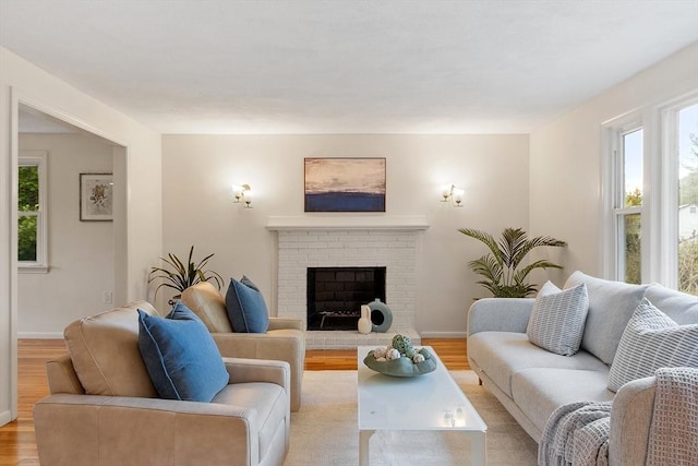 living room with healthy amount of natural light, light wood finished floors, and baseboards
