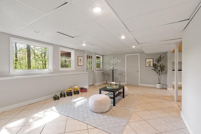 sitting room featuring light tile patterned floors, a drop ceiling, baseboards, and recessed lighting
