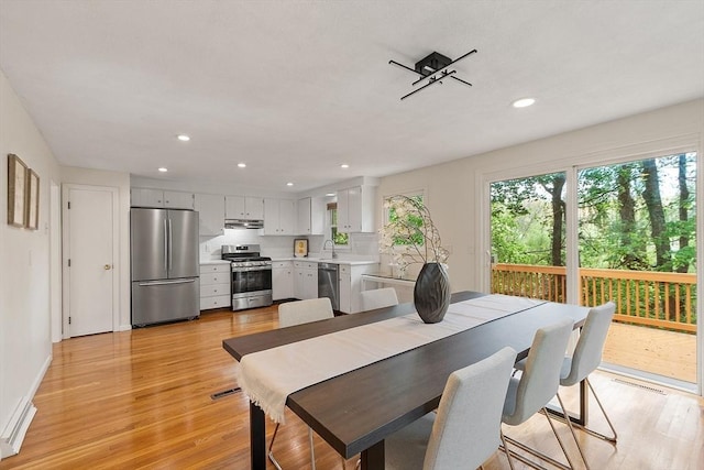dining area with light wood-style floors, recessed lighting, and baseboards