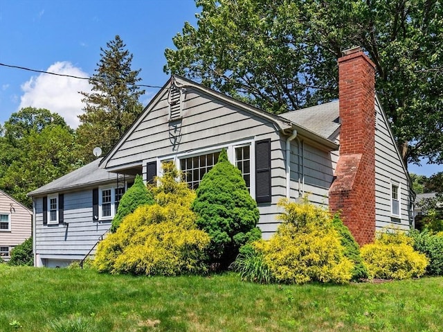 29 Gregory Rd, Wakefield, MA 01880 - bungalow-style house with a chimney and a front lawn