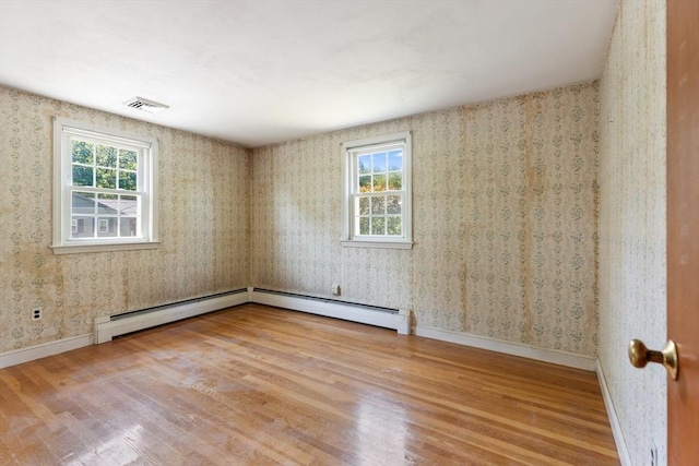 29 Gregory Rd, Wakefield, MA 01880 - unfurnished room with wood finished floors, a baseboard radiator, and wallpapered walls