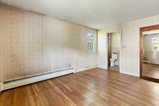 29 Gregory Rd, Wakefield, MA 01880 - spare room with a baseboard radiator, wood finished floors, plenty of natural light, and wallpapered walls