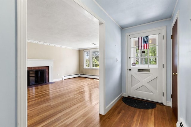 29 Gregory Rd, Wakefield, MA 01880 - foyer entrance with crown molding, wood finished floors, a brick fireplace, and baseboard heating