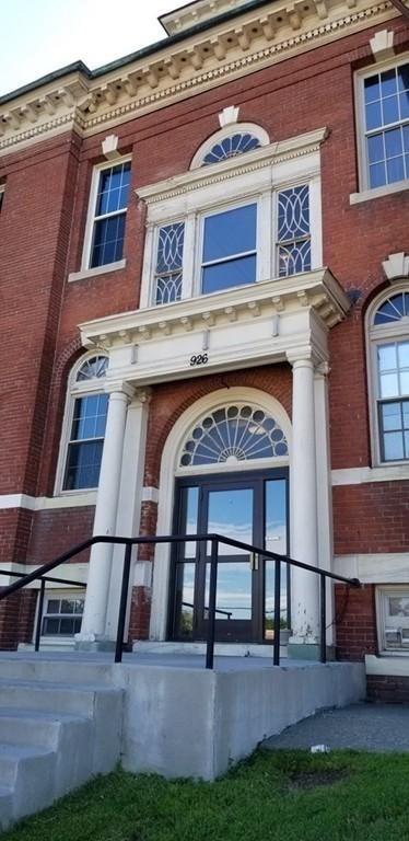 doorway to property with brick siding