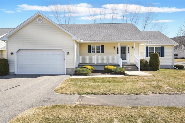 ranch-style home featuring a porch, a garage, roof with shingles, and a front lawn