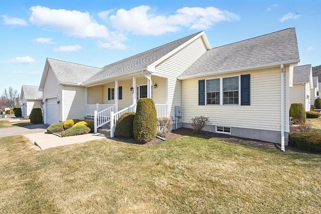 ranch-style home with a porch, an attached garage, a front yard, and roof with shingles