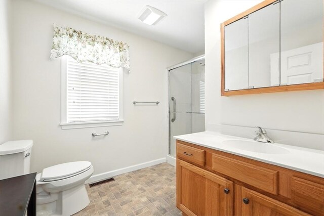 full bathroom featuring visible vents, a shower stall, baseboards, toilet, and vanity