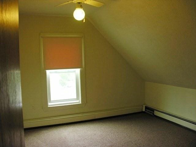 bonus room with carpet floors, vaulted ceiling, and a ceiling fan