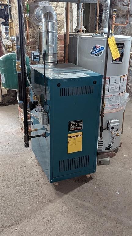 utility room featuring gas water heater