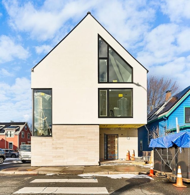 rear view of property with stucco siding