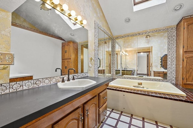 466 Hosmer St, Marlborough, MA 01752 - full bath featuring a skylight, vaulted ceiling, a whirlpool tub, vanity, and wallpapered walls